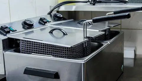 A close up of an open fryer with the lid closed