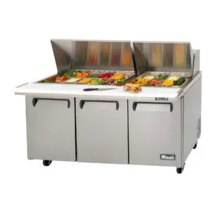 A three door sandwich prep table with food on top.